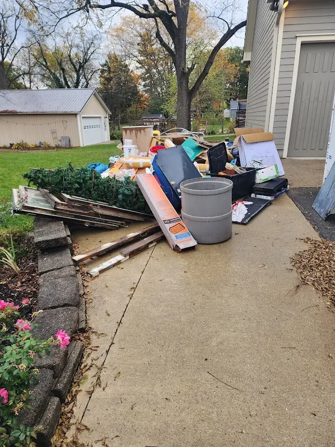 Dumpster being loaded with debris for 12 Yard Dumpster Rental in French Valley